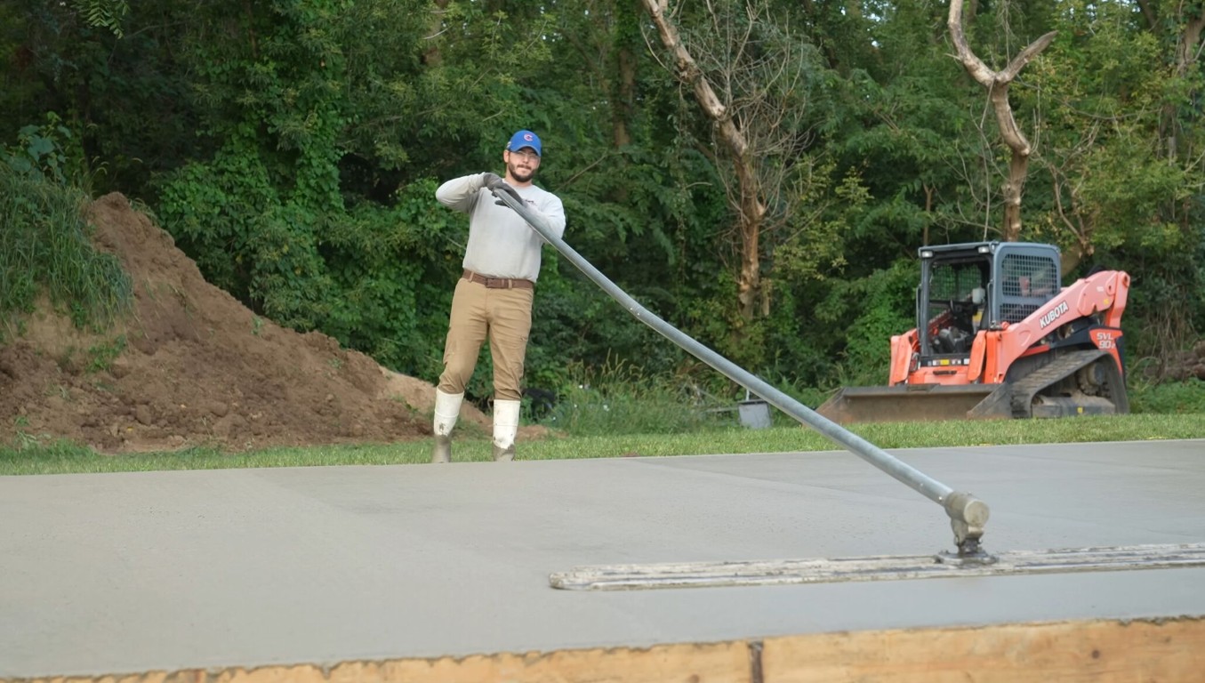 Professional concrete contractor working on a new driveway installation in Vero Beach, FL